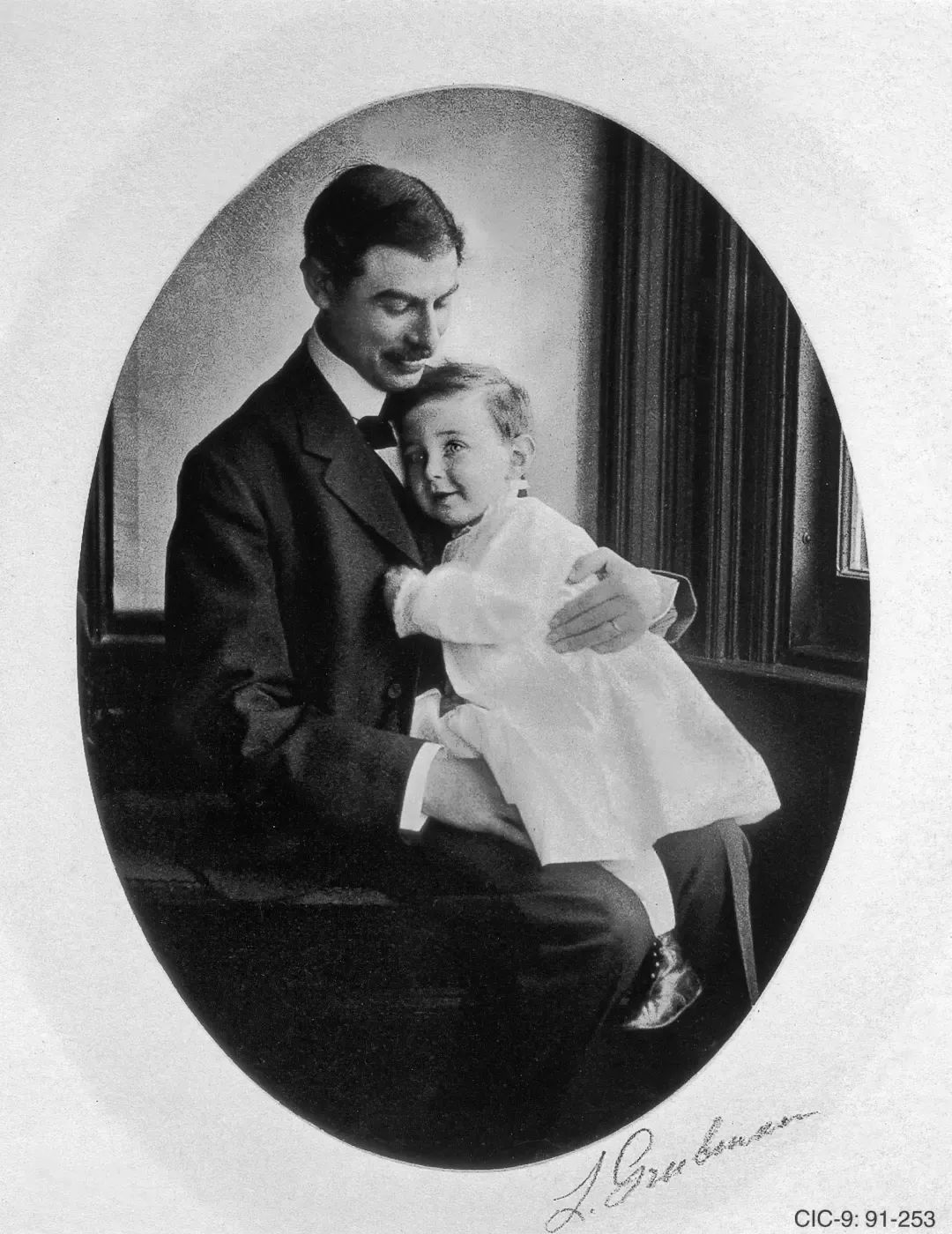 幼年奥本海默坐在父亲的膝头