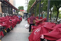 网友称赞雨天给顾客电瓶车搭雨披 胖东来：一直有这项服务